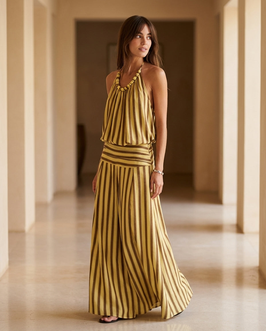 Butter Yellow Charm Resort Striped Romper Butter Yellow Romper with Relaxed Fit silhouette and Textured texture, editorial ecommerce scene for Resort Wear, an estate dinner at golden hour, US East / Hamptons Elite by floravincie
