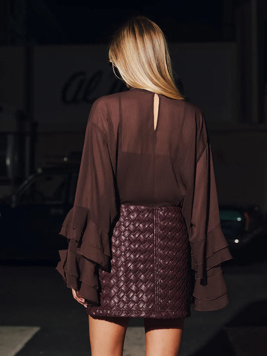 Sheer shirt paired with a woven leather skirt set