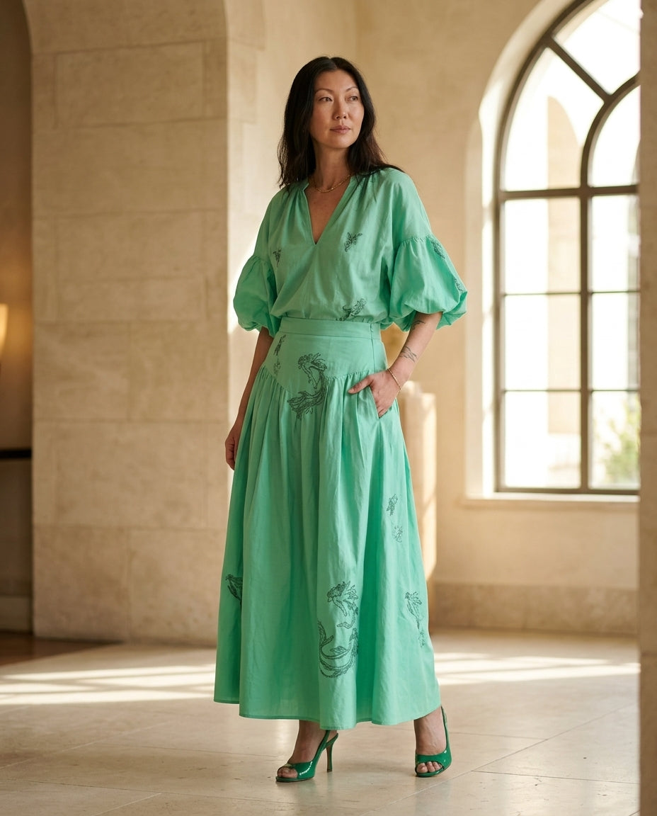 Mint Green Eyelet V-Neck Skirt Set "Chiara" Mint Green Skirt Set with Relaxed Fit silhouette and Textured texture, editorial ecommerce scene for Resort Wear, a London dinner reservation, Euro Chic Premium