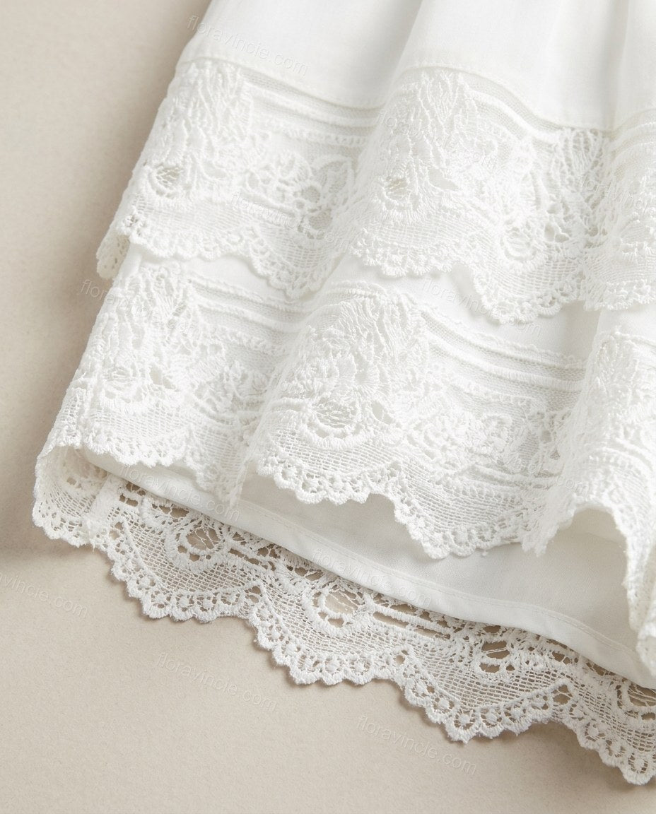 White Tiered Lace Jumpsuit, close-up of lace trim, tiered design and intricate lace overlay on bodice, by Floravincie